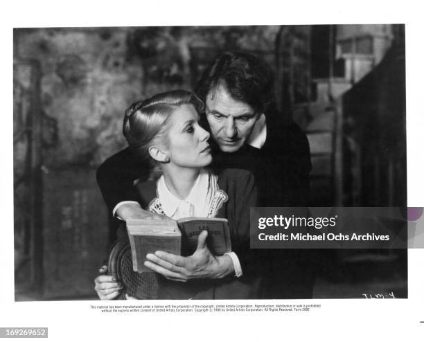 Catherine Deneuve looks up as Heinz Bennent reads over her shoulder in a scene from the film 'The Last Metro', 1980.