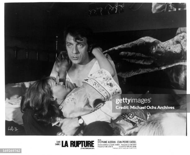 Stephane Audran holding onto Jean-Pierre Cassel in bed in a scene from the film 'The Breach', 1970.