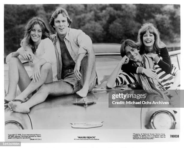 Kim Lankford, James Daughton, Michael Luther, and Susan Player on top of car in publicity portrait for the film 'Malibu Beach', 1978.