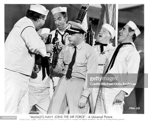 Tim Conway becomes 'pie-eyed' as a result of making numerous toasts with the crew in a scene from the film 'McHale's Navy Joins The Air Force', 1965.