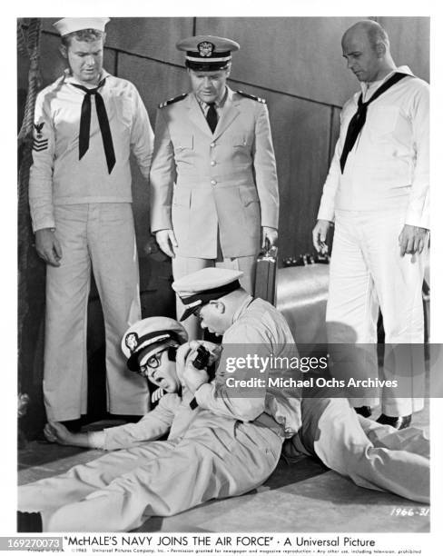 Gary Vinson, Bob Hastings, and Gavin MacLeod gather around as Tim Conway tries to take an up close picture of Joe Flynn in a scene from the film...