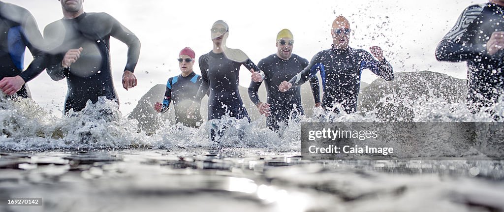 Triathletes emerging from water