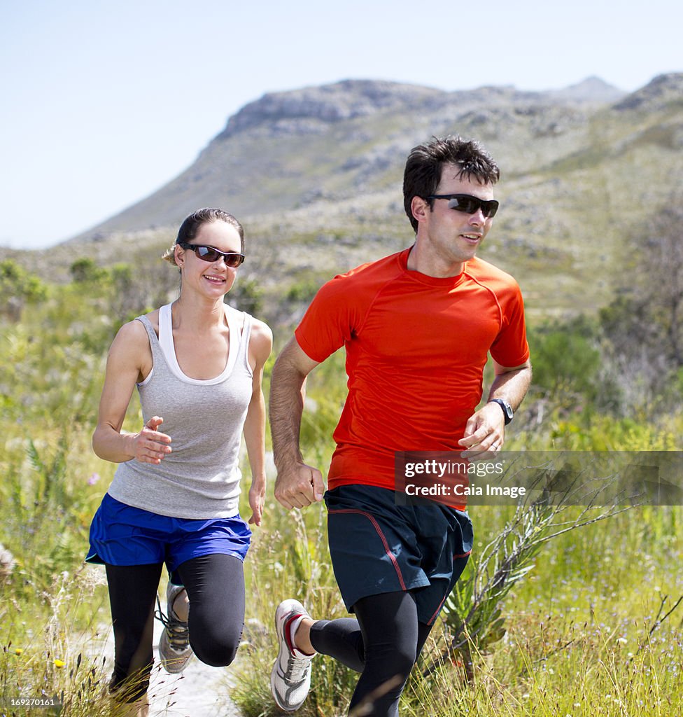 Couple running on dirt path