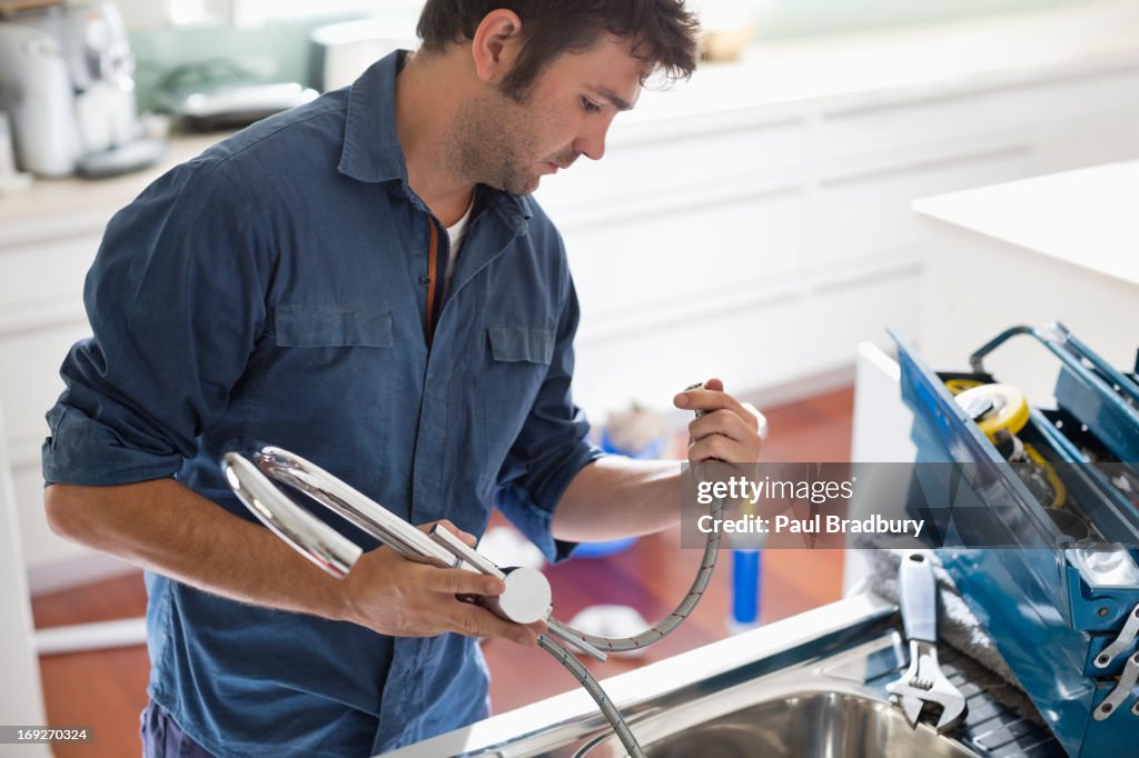 Plumber working on kitchen sink