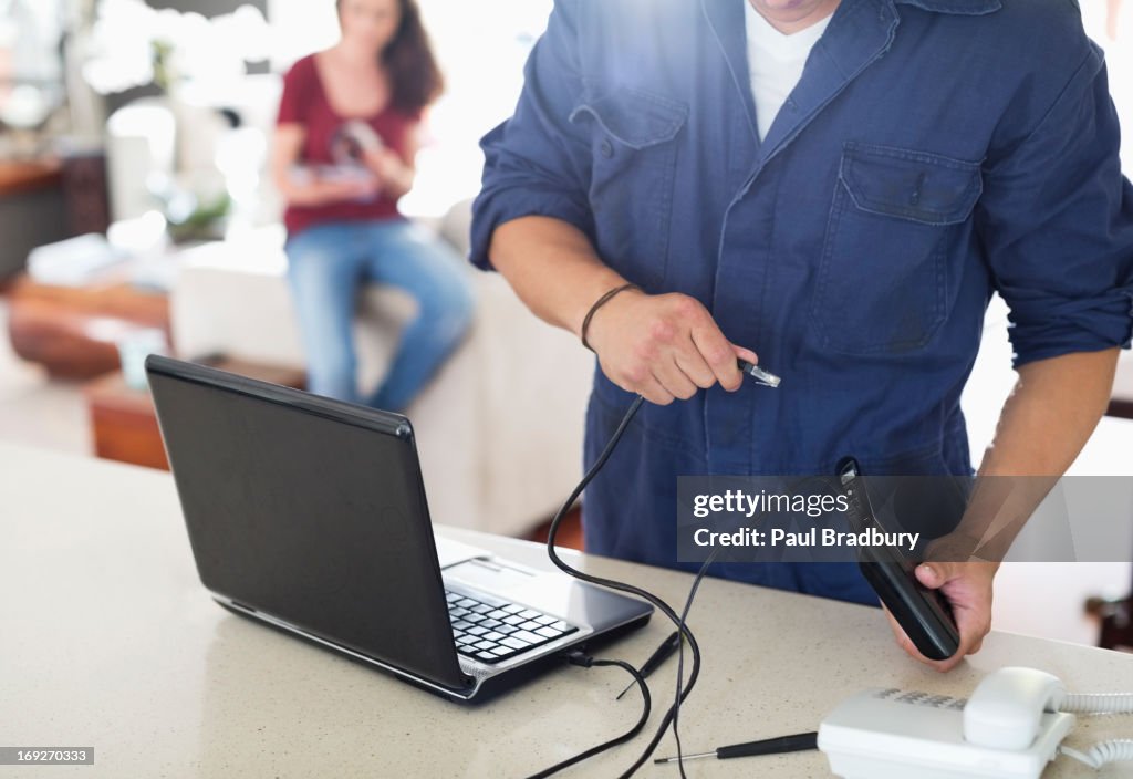 Electrician using laptop in home