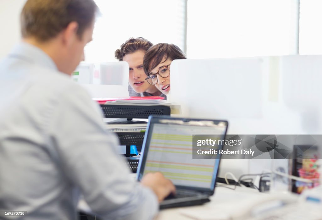 Business people eavesdropping on colleague