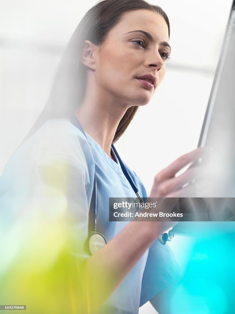 Doctor using tablet computer in hospital