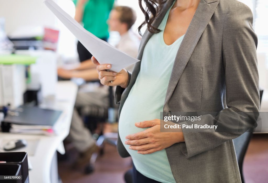 Pregnant businesswoman working in office