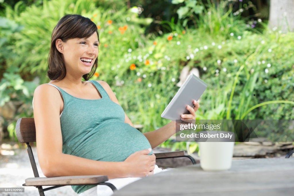 Pregnant woman using tablet computer