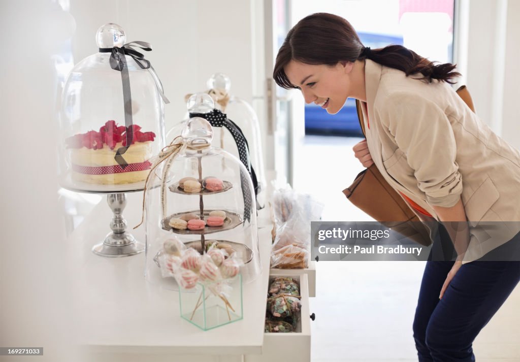 Woman admiring cookies in store