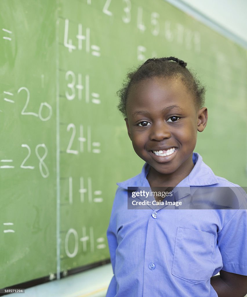 Student smiling at chalkboard