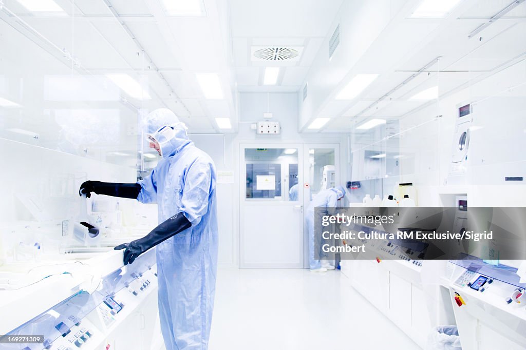 Scientists using equipment in lab