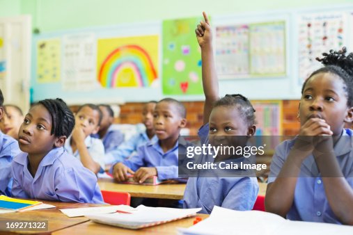 Student raising hand in class Student raising hand in class