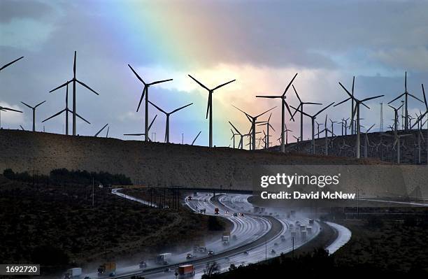 Rainbow forms behind giant windmills near rain-soaked Interstate 10 as an El Nino-influenced storm passes over the state on December 17, 2002 near...