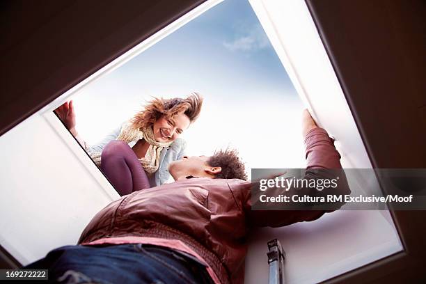 young couple opening hatch to roof terrace - vehicle hatch stock pictures, royalty-free photos & images