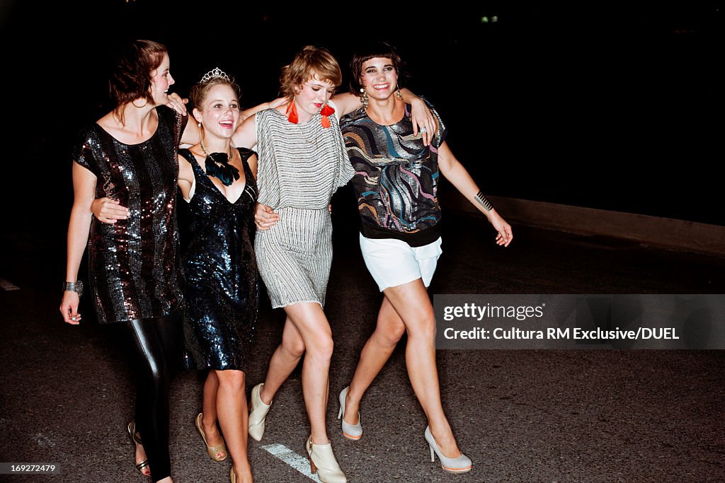 Young women walking along road to party