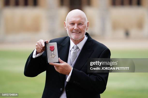 Commodore David Pond, former chief executive of Britain Wheelchair Rugby , poses after being made Member of the Order of the British Empire at an...