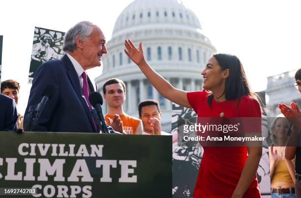 Rep. Alexandria Ocasio-Cortez hugs Sen. Ed Markey as they speak at a news conference on the launch of the American Climate Corps outside the U.S....