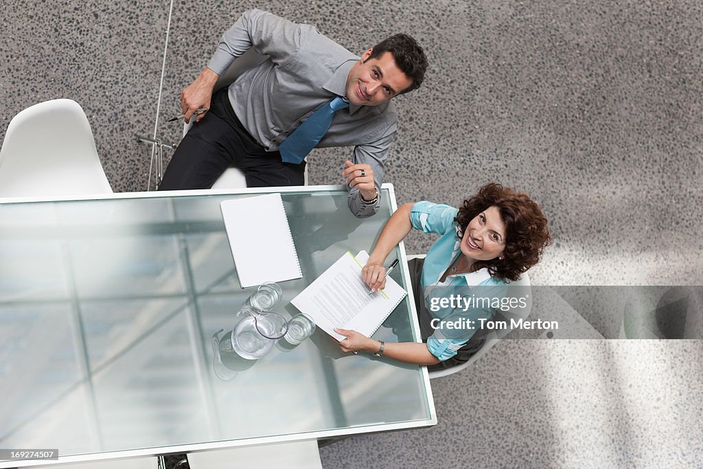 Businessman and businesswoman looking up