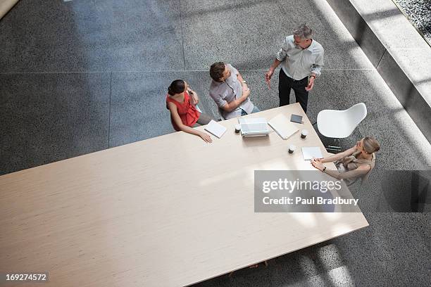 business people meeting at conference table - directly above office stock pictures, royalty-free photos & images