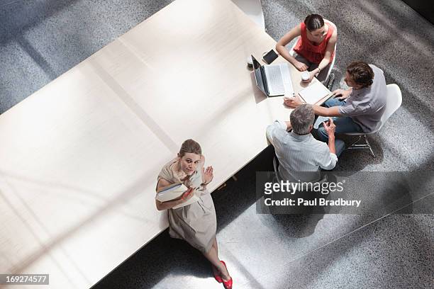 directly above business people meeting in conference room - looking above stockfoto's en -beelden