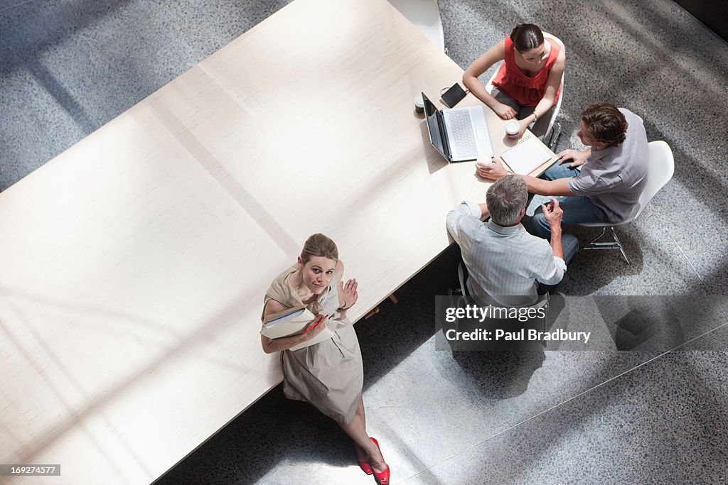 Directly above business people meeting in conference room