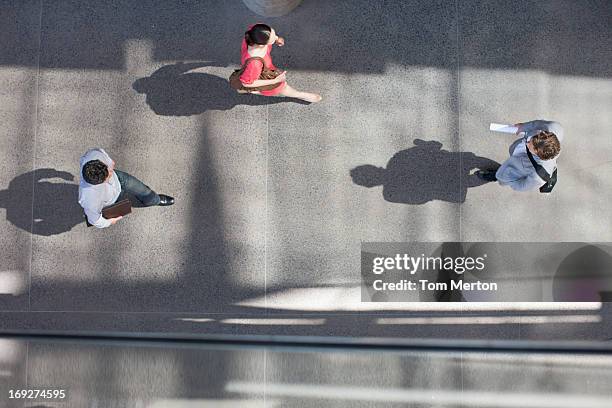 shadows of people walking from directly above - overhead view office stock pictures, royalty-free photos & images