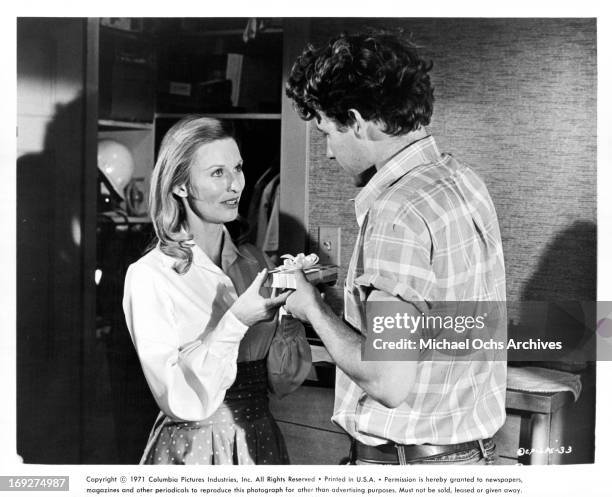 Cloris Leachman offering present to Timothy Bottoms in a scene from the film 'The Last Picture Show', 1971.