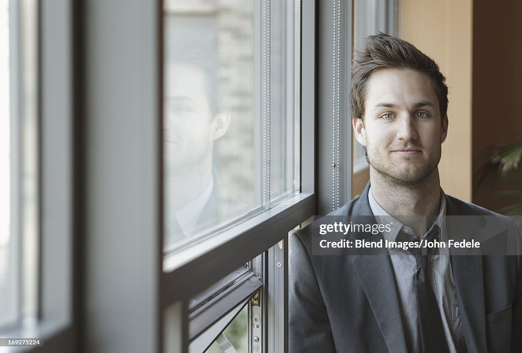 Businessman standing at window