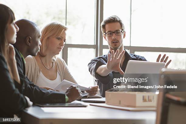 business people using laptop in meeting - persuasion imagens e fotografias de stock