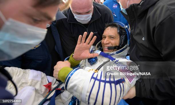 In this handout provided by NASA, Expedition 69 NASA astronaut Frank Rubio is helped out of the Soyuz MS-23 spacecraft just minutes after he and...