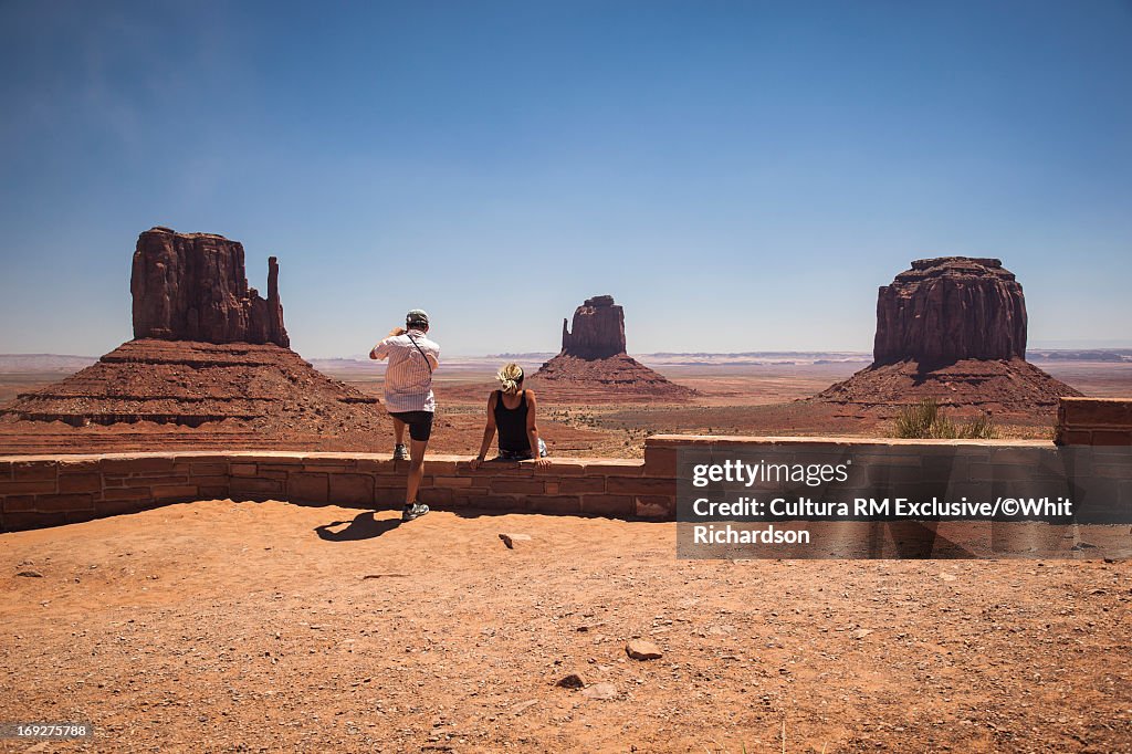 Tourists admiring desert rock formations