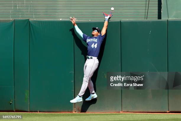 Julio Rodriguez of the Seattle Mariners can not catch a home run ball hit by Brent Rooker of the Oakland Athletics in the sixth inning at RingCentral...