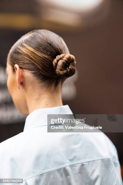 Guest is seen wearing her hair in a bun with a white shirt outside the Fendi show during Milan Fashion Week Womenswear Spring/Summer 2024 on...