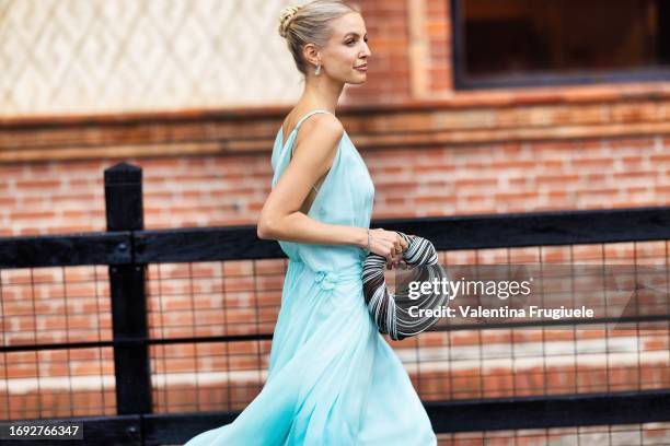 Leonie Hanne is seen wearing a light blue chiffon dress and a Bottega Veneta Mini Jodie bag outside the Alberta Ferretti show during Milan Fashion...