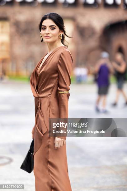 Flora Delle Vacche is seen wearing a silk satin copper dress outside the Alberta Ferretti show during Milan Fashion Week Womenswear Spring/Summer...