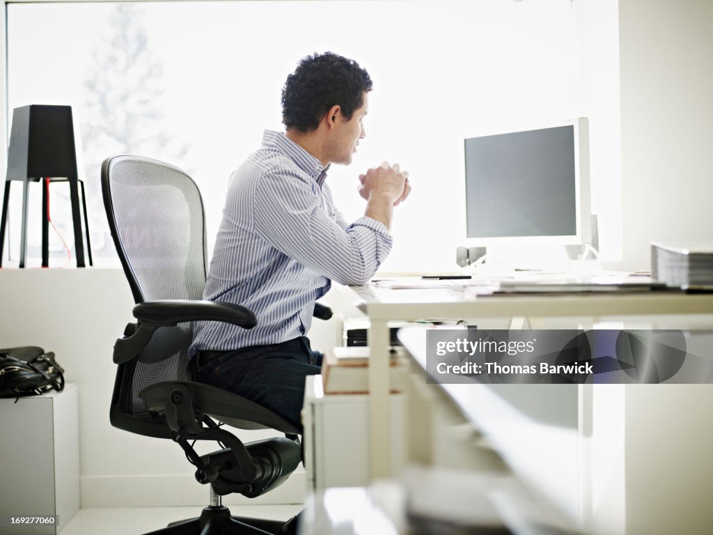 Businessman at desk in high tech startup office