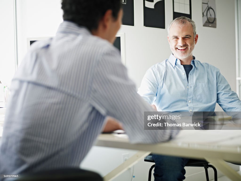 Businessmen in discussion in startup office