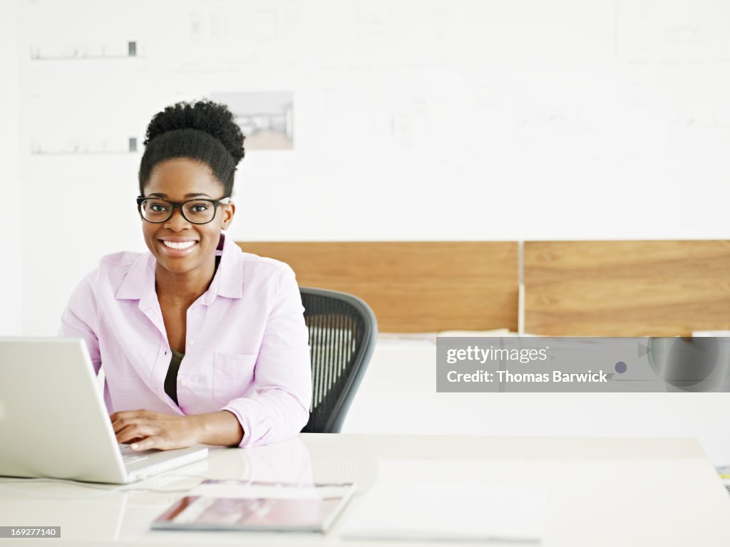 Businesswoman working on laptop in startup office