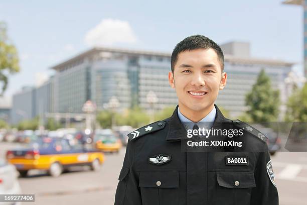 police officer smiling, portrait, china - police respect stock pictures, royalty-free photos & images