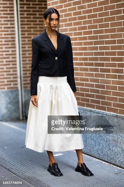 Kelly Gale is seen wearing a white wide skirt and short black blazer outside Fendi show during the Milan Fashion Week - Womenswear Spring/Summer 2024...