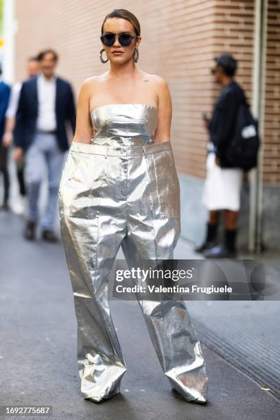 Guest is seen wearing silver crop top and really oversized pants outside the Fendi show during Milan Fashion Week Womenswear Spring/Summer 2024 on...