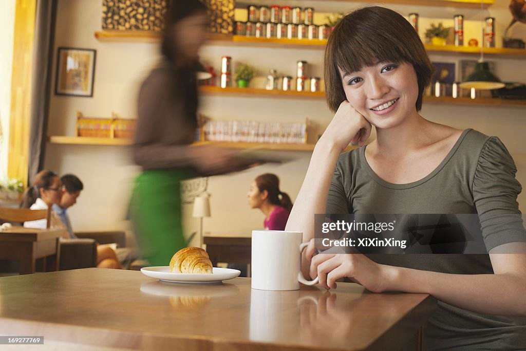 Portrait of young woman at a coffee shop, Beijing