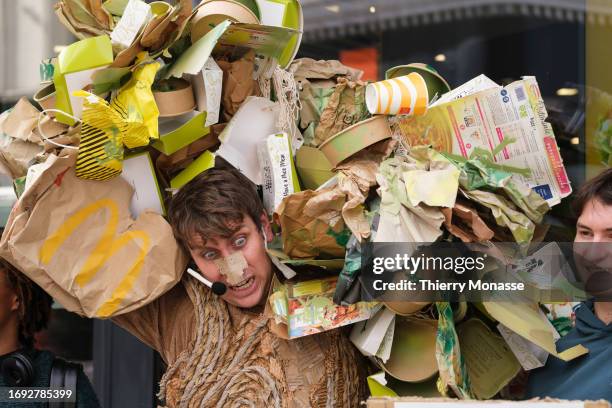 Activists from Fern and the Environmental Paper Network demonstrate in front of the 'McDonalds Porte de Namur' to call out McDonald's for their...