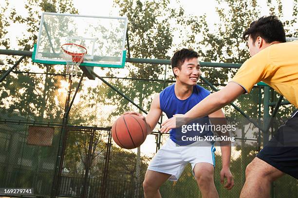 two street basketball players on the basketball court - asian games day 2 stock-fotos und bilder