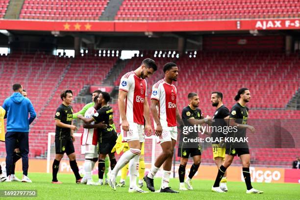 Ajax's Josip Sutalo and Chuba Akpom leave the pitch after losing the Dutch Eredivisie football match between Ajax Amsterdam and Feyenoord Rotterdam...