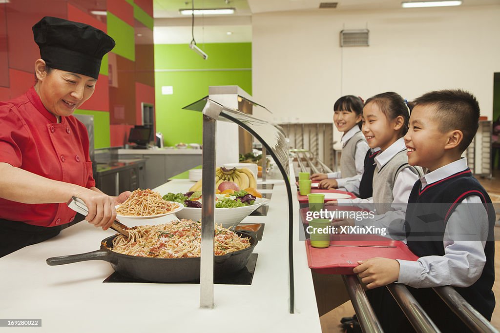 School children standing in line in school cafeteria