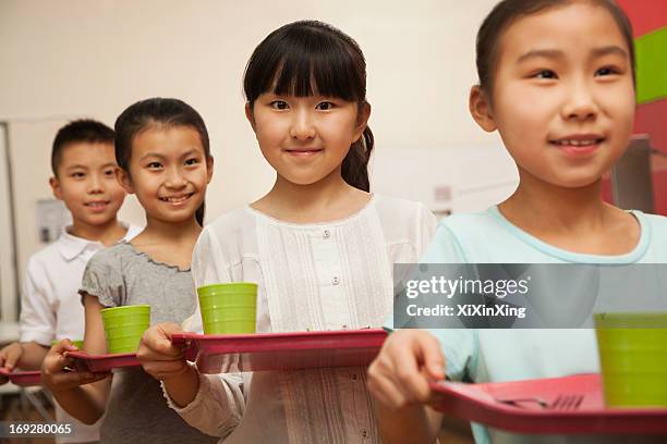 row of students standing in line in school cafeteria - young choice beijing activity stock pictures, royalty-free photos & images