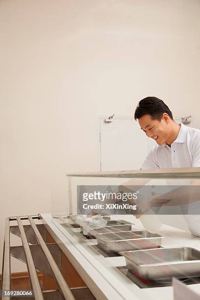 cafeteria worker cleaning food serving area - school caretaker stock pictures, royalty-free photos & images
