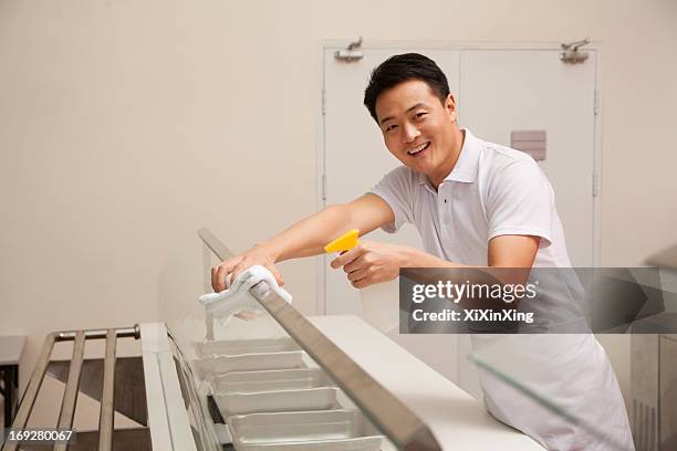 cafeteria worker cleaning food serving area - disinfection school stock pictures, royalty-free photos & images